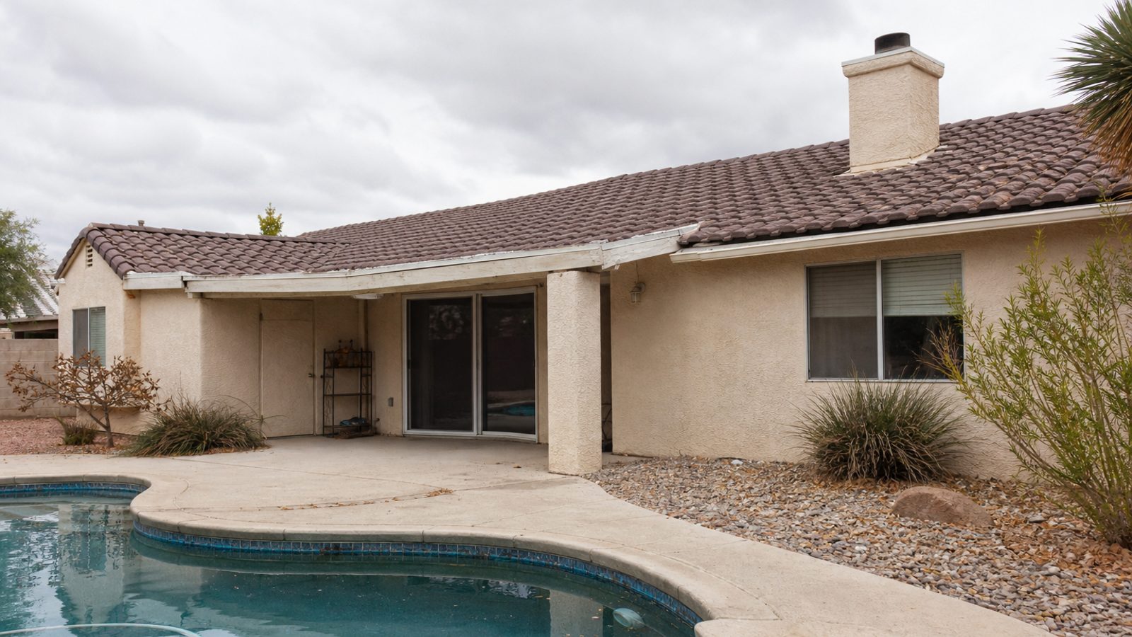 Nevada residential exterior with xeriscape and dry-air weathering around pool patio materials